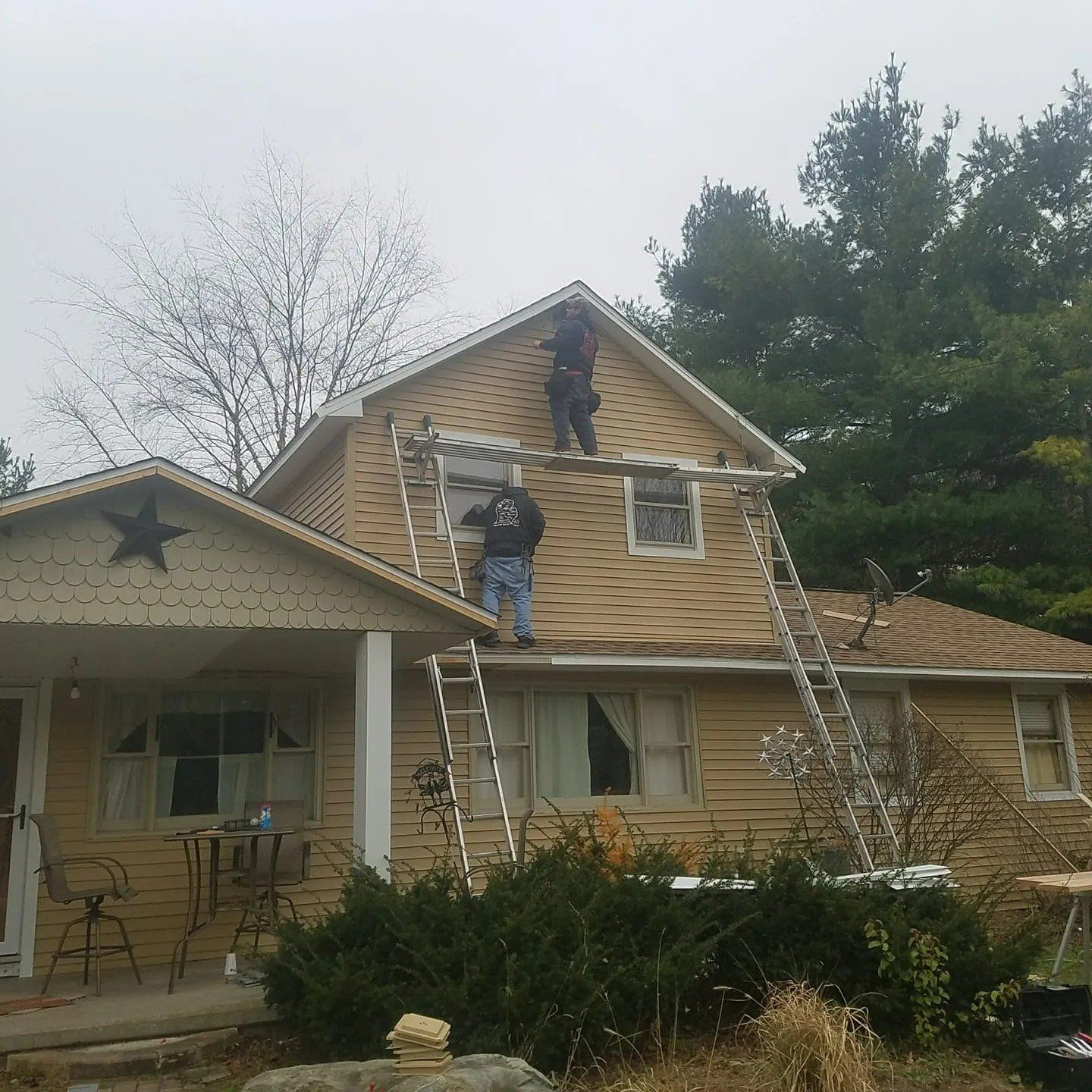 Roofers on Ladders Leaning on House – Saline, MI – Diversified Roofing