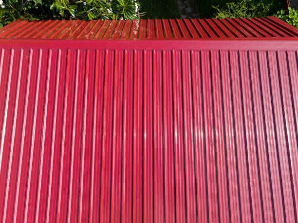 A red, sturdy metal roofing, exemplifying a modern and chic architectural style for a property.