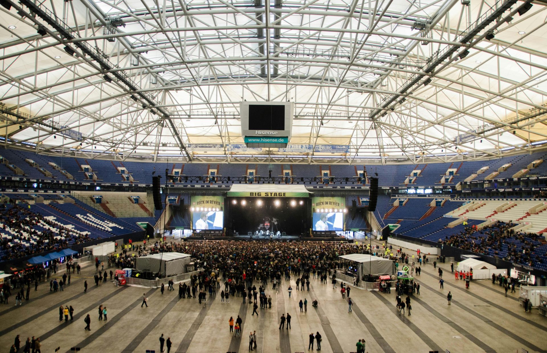 A large stadium filled with people watching a concert