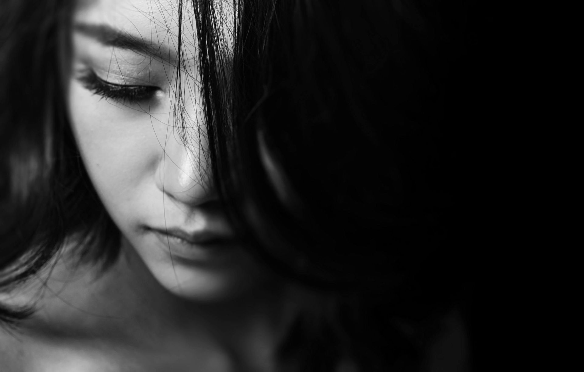 A close up of a woman 's face in a black and white photo.