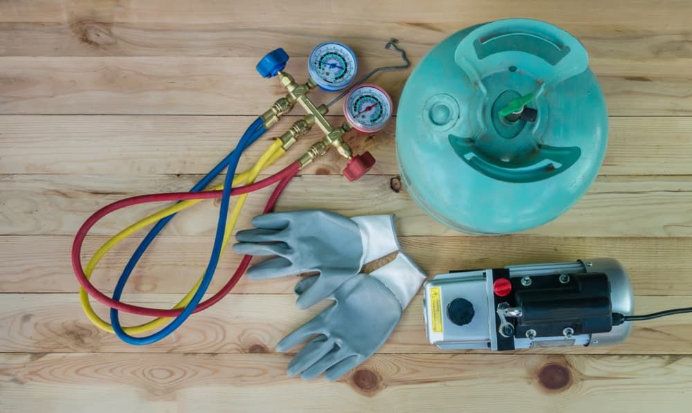 Refrigeration Tools on Wood: Gauges, Hoses, Gloves, Vacuum Pump — FNQ Filters & Parts In Mareeba, QLD