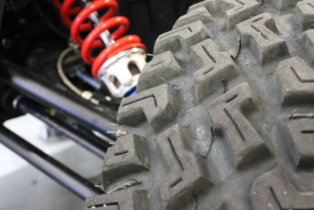 A Close Up of a Tire and Shock on a Vehicle — FNQ Filters & Parts In Mareeba, QLD