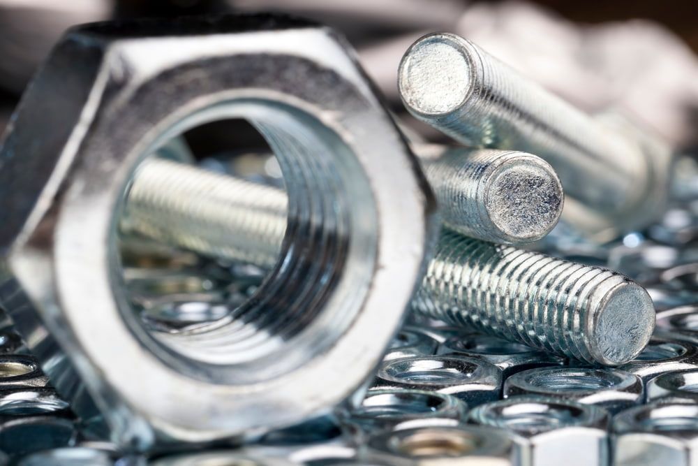 A Close Up of Nuts and Bolts on a Table — FNQ Filters & Parts In Mareeba, QLD