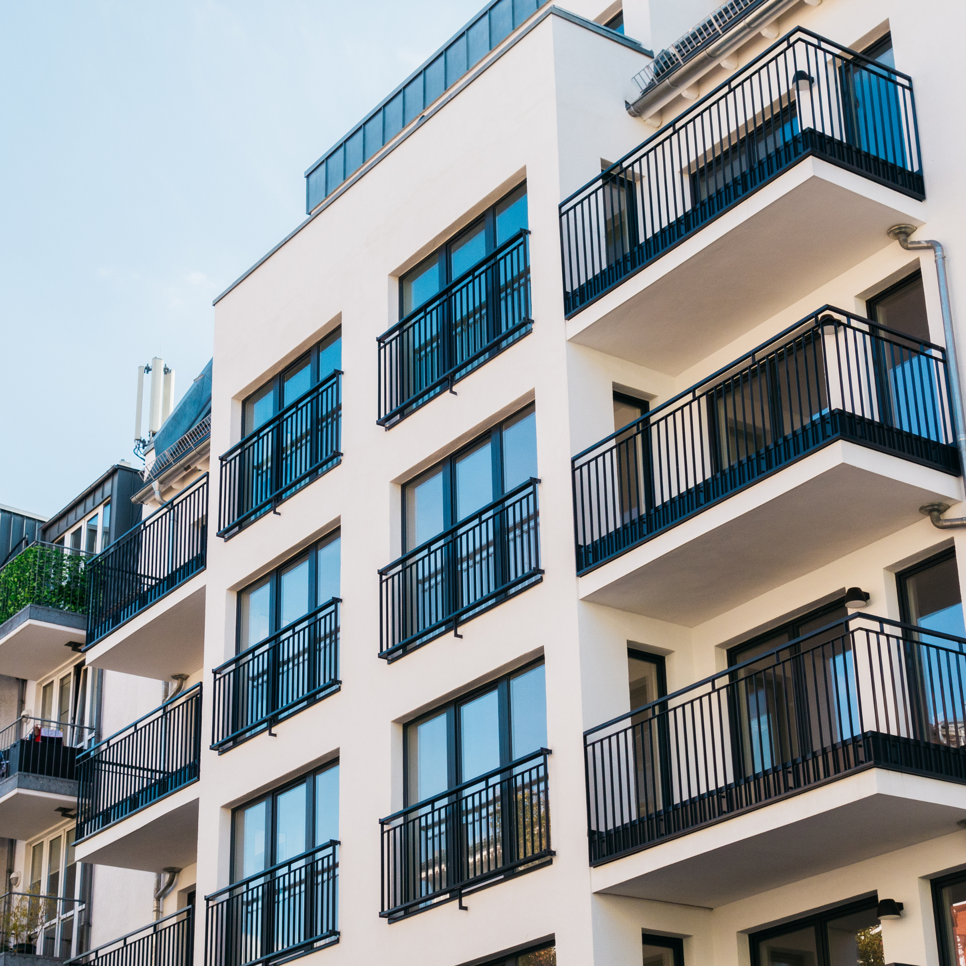 A large apartment building with many balconies and windows