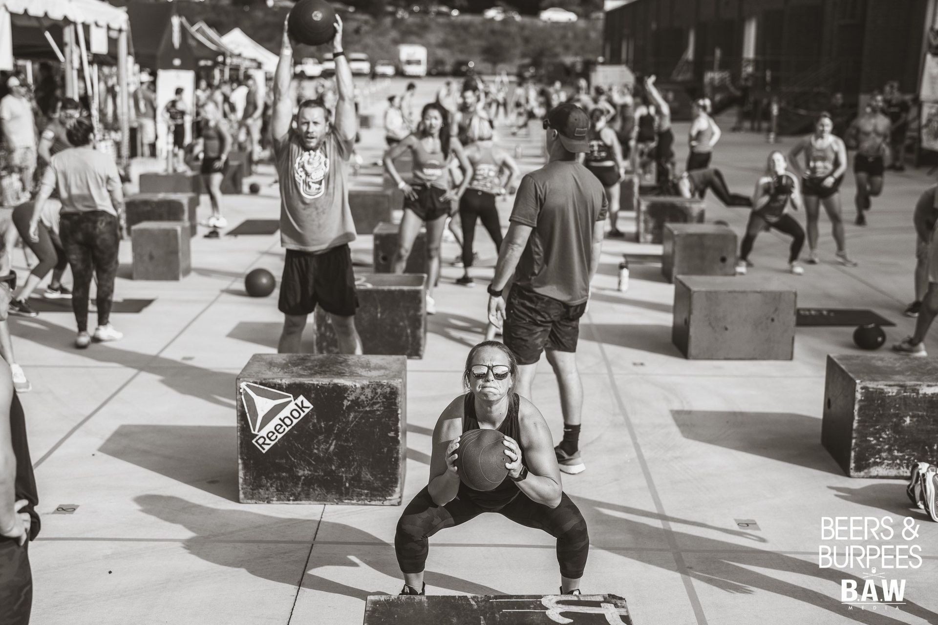 A group of people performing at a CrossFit event.
