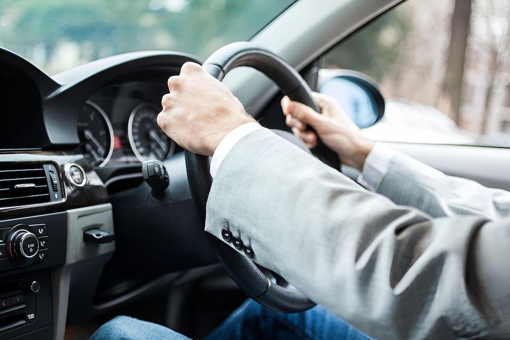 Person's Hands Gripping Steering Wheel of a Car — Fulgi's South Coast Automotive and Dismantling in Shellharbour, NSW