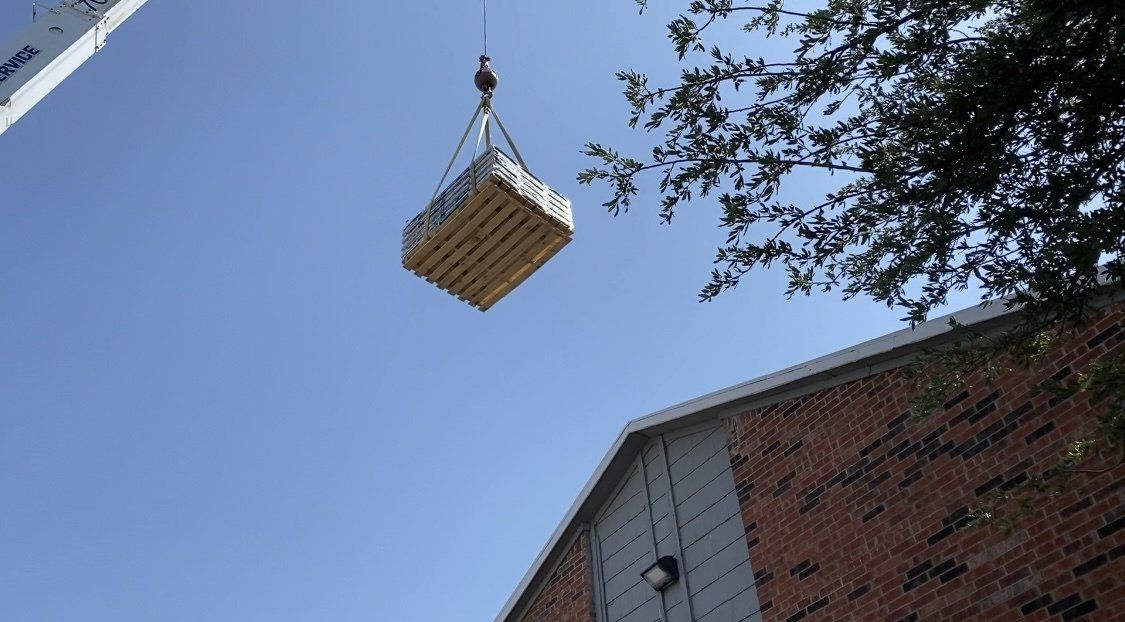 Crane Lifting Roofing Materials in Abilene and San Angelo, TX