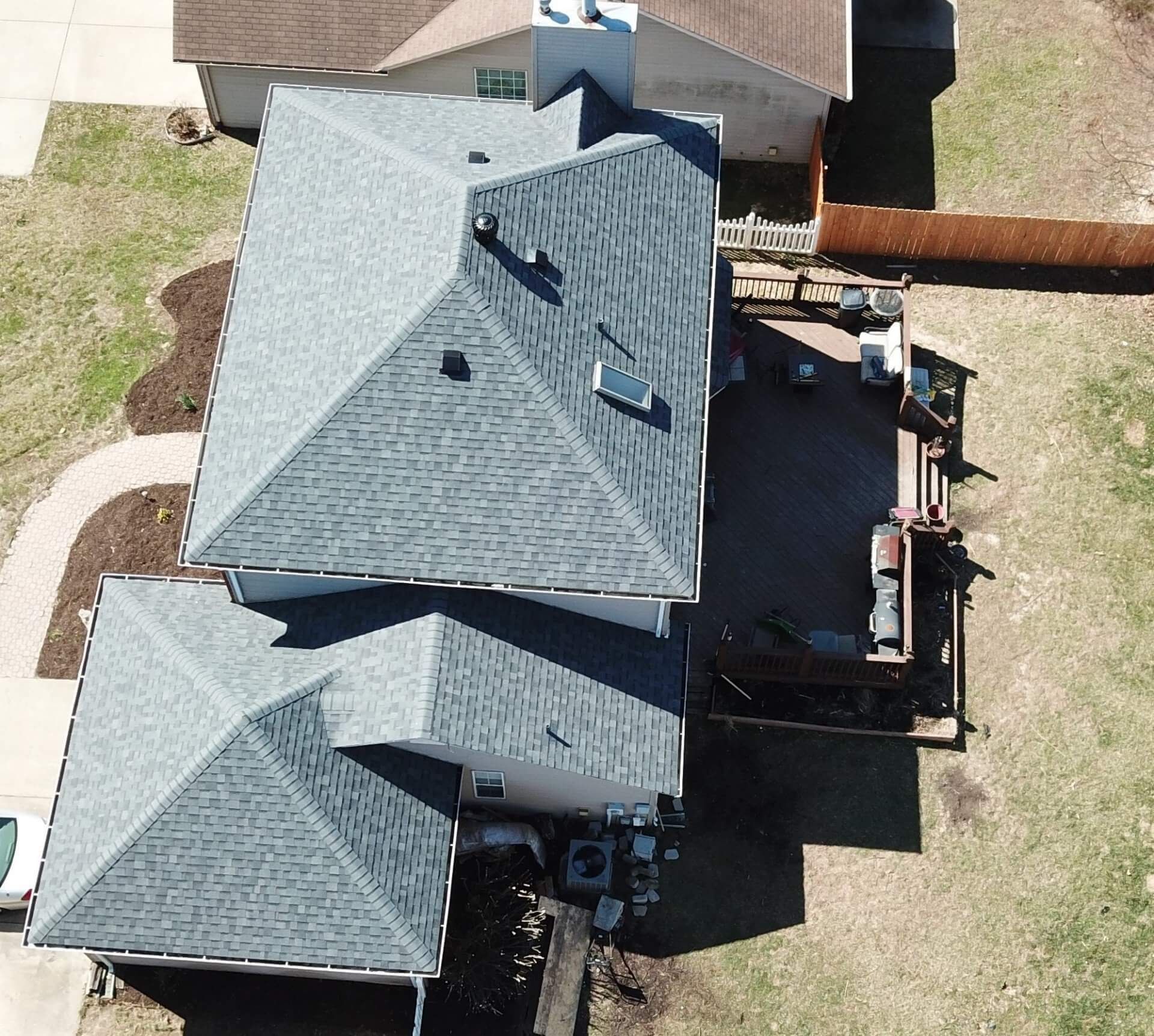 An aerial view of a house with a gray roof