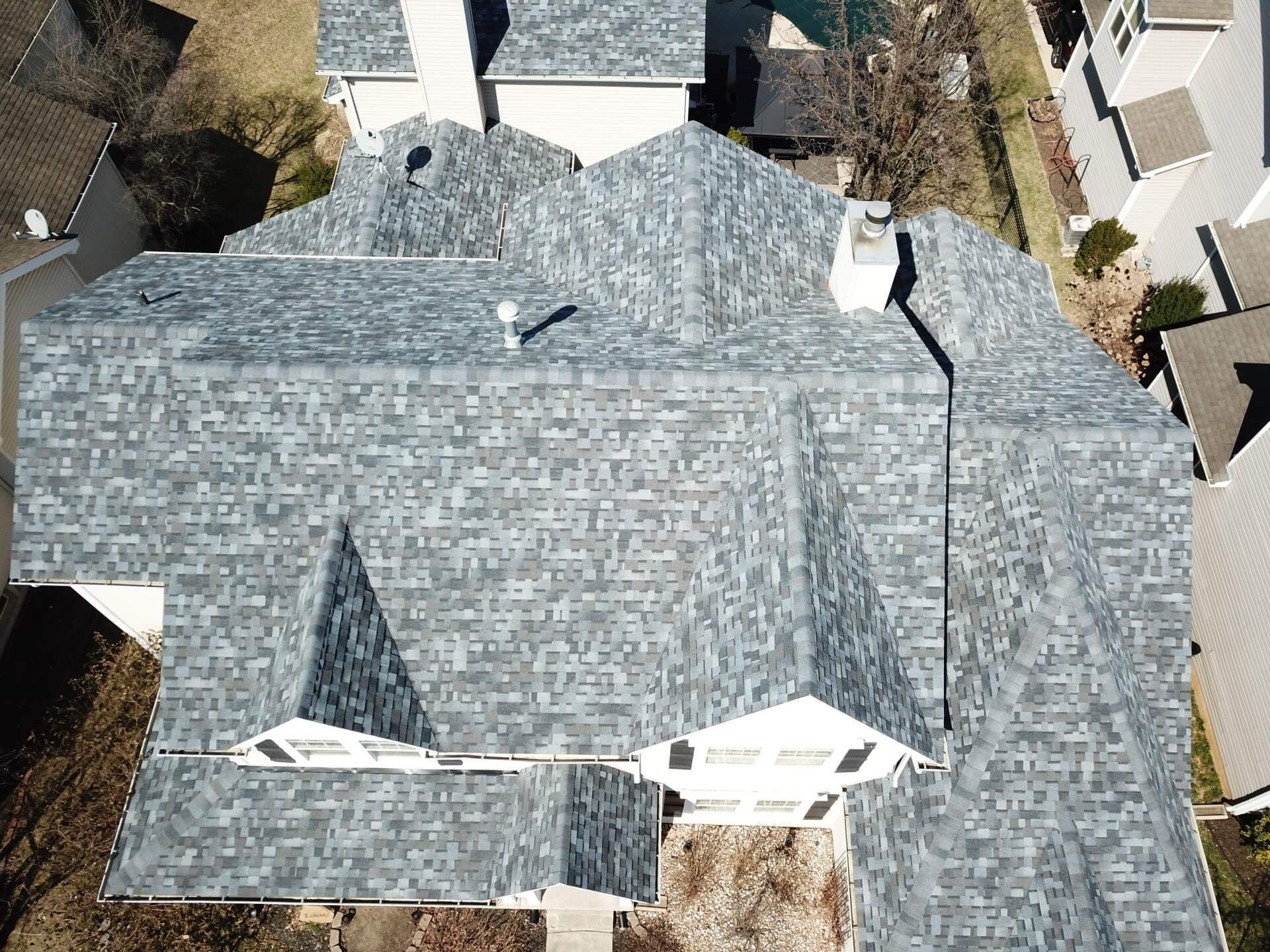 An aerial view of a house with a new roof.