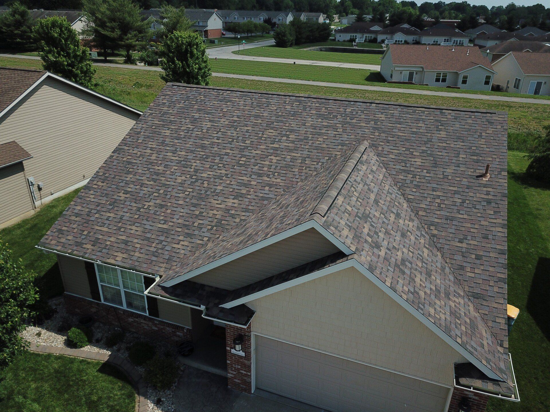An aerial view of a house with a new roof.