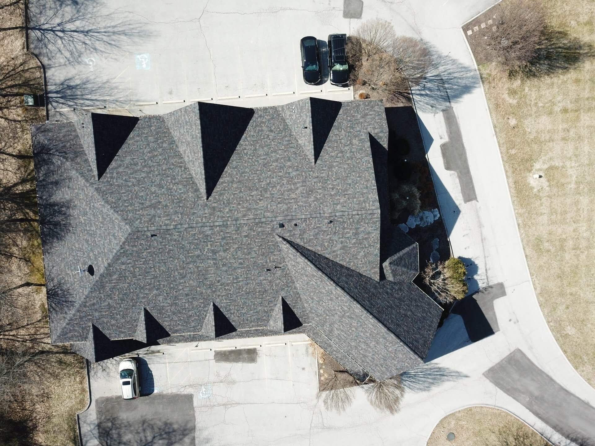 An aerial view of a house with a triangle shaped roof.
