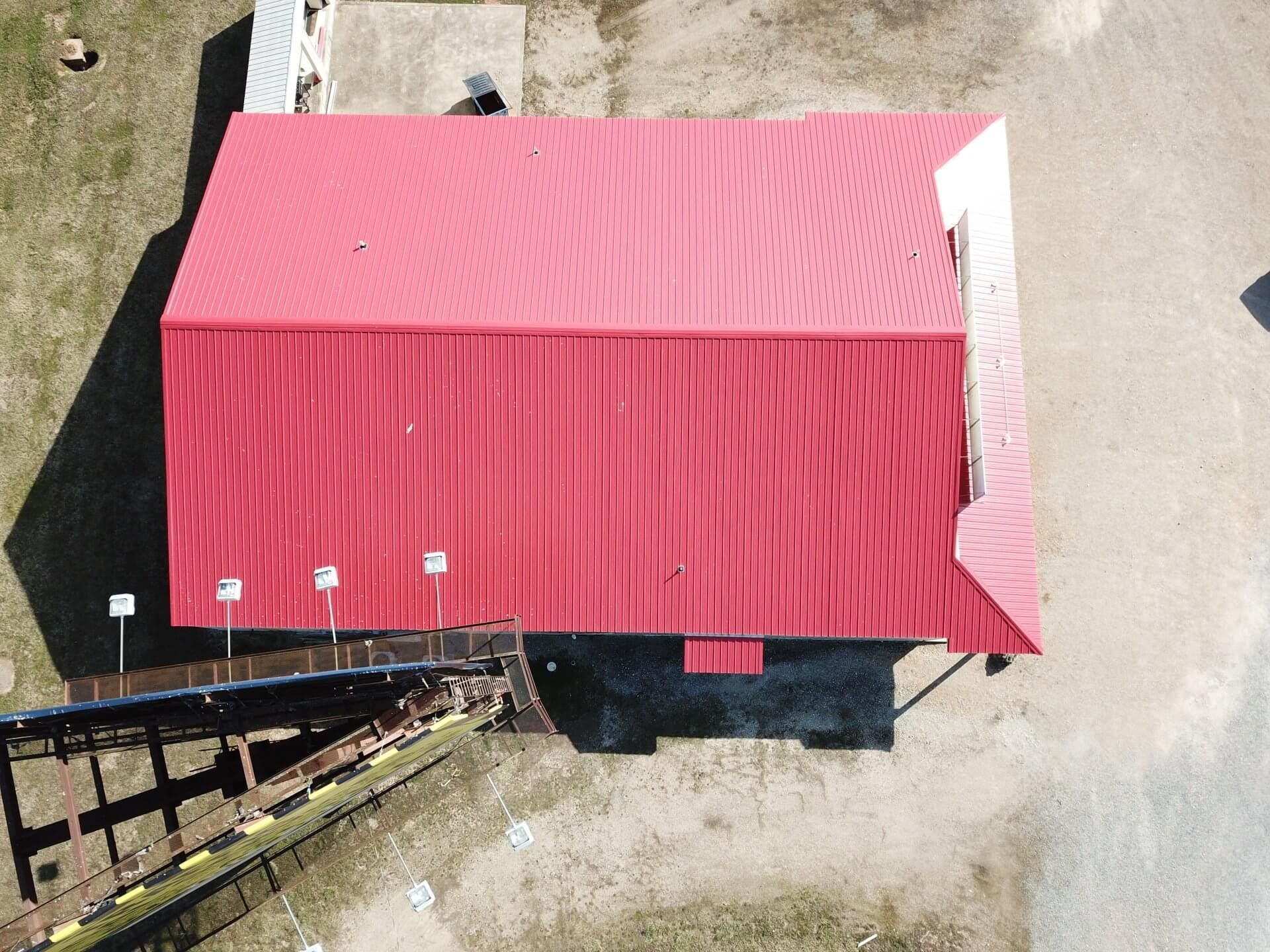 An aerial view of a red building with a red roof