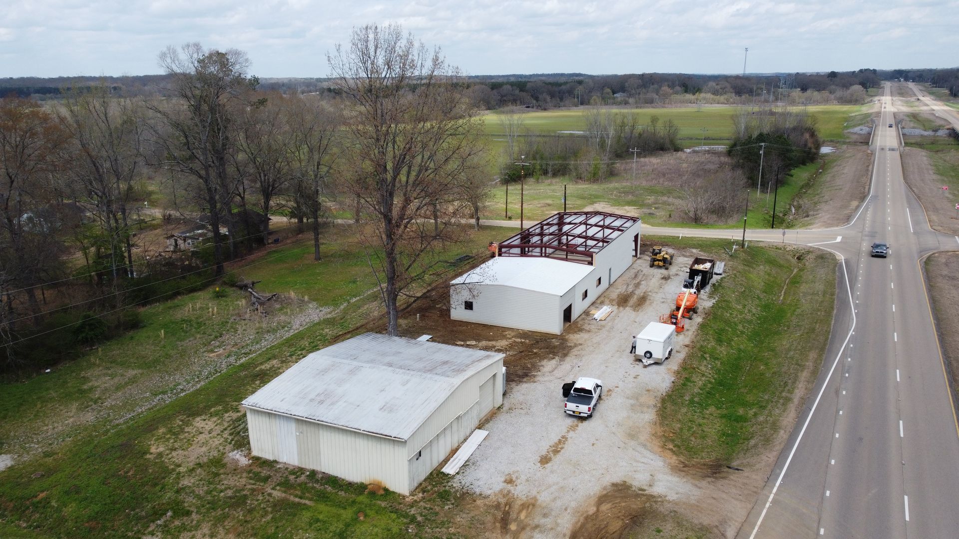 An aerial view of a building next to a highway.