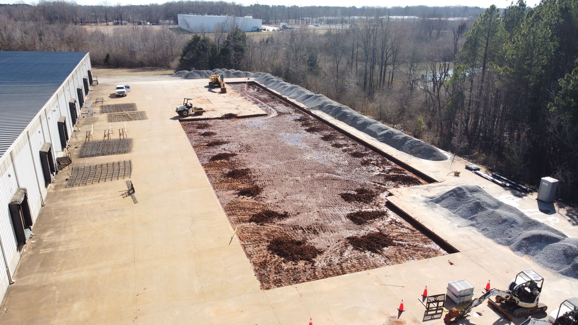 An aerial view of a warehouse roof with a lot of dirt on it