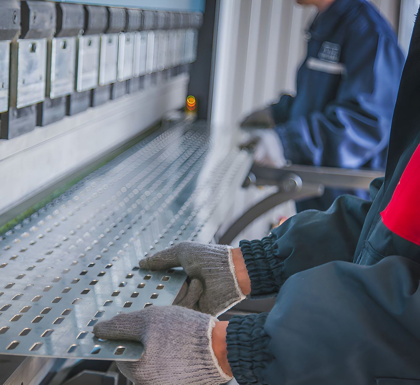A Person Wearing Gloves Is Working On A Machine In A Factory — Sno's Welding In Ciccone, NT