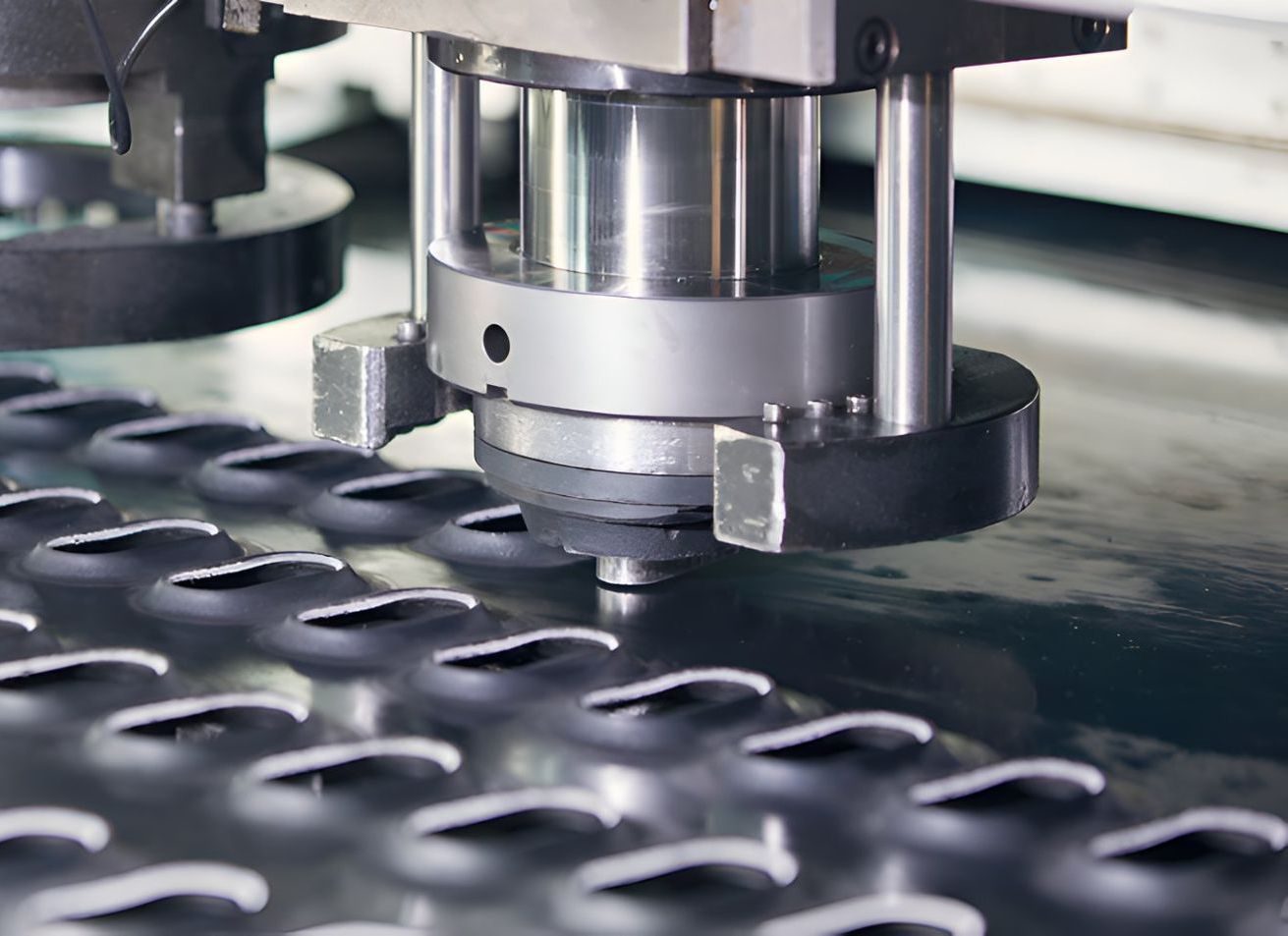 A Machine Is Cutting Holes In A Piece Of Metal — Sno's Welding In Ciccone, NT