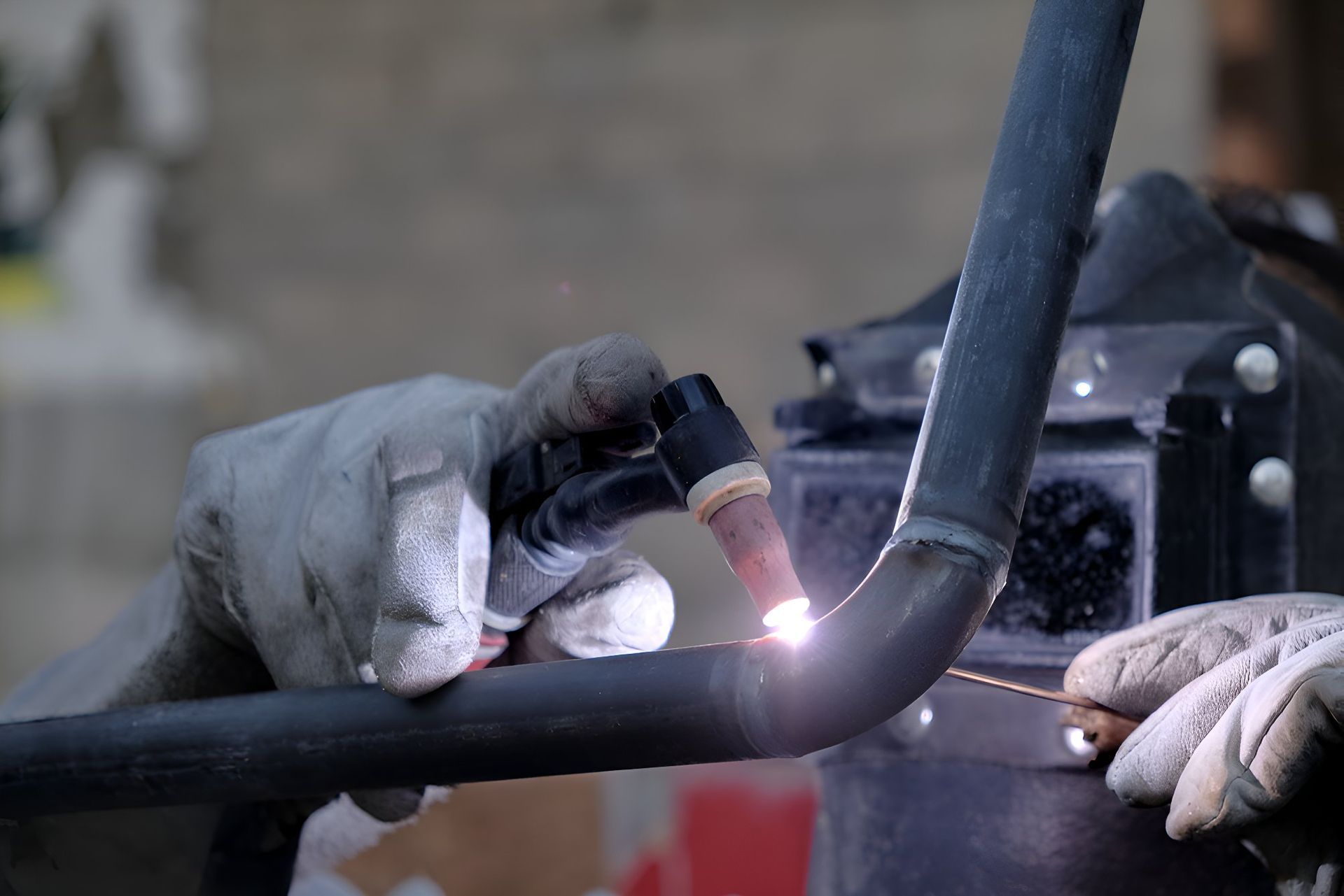 A Person Is Welding A Pipe With A Torch — Sno's Welding In Ciccone, NT