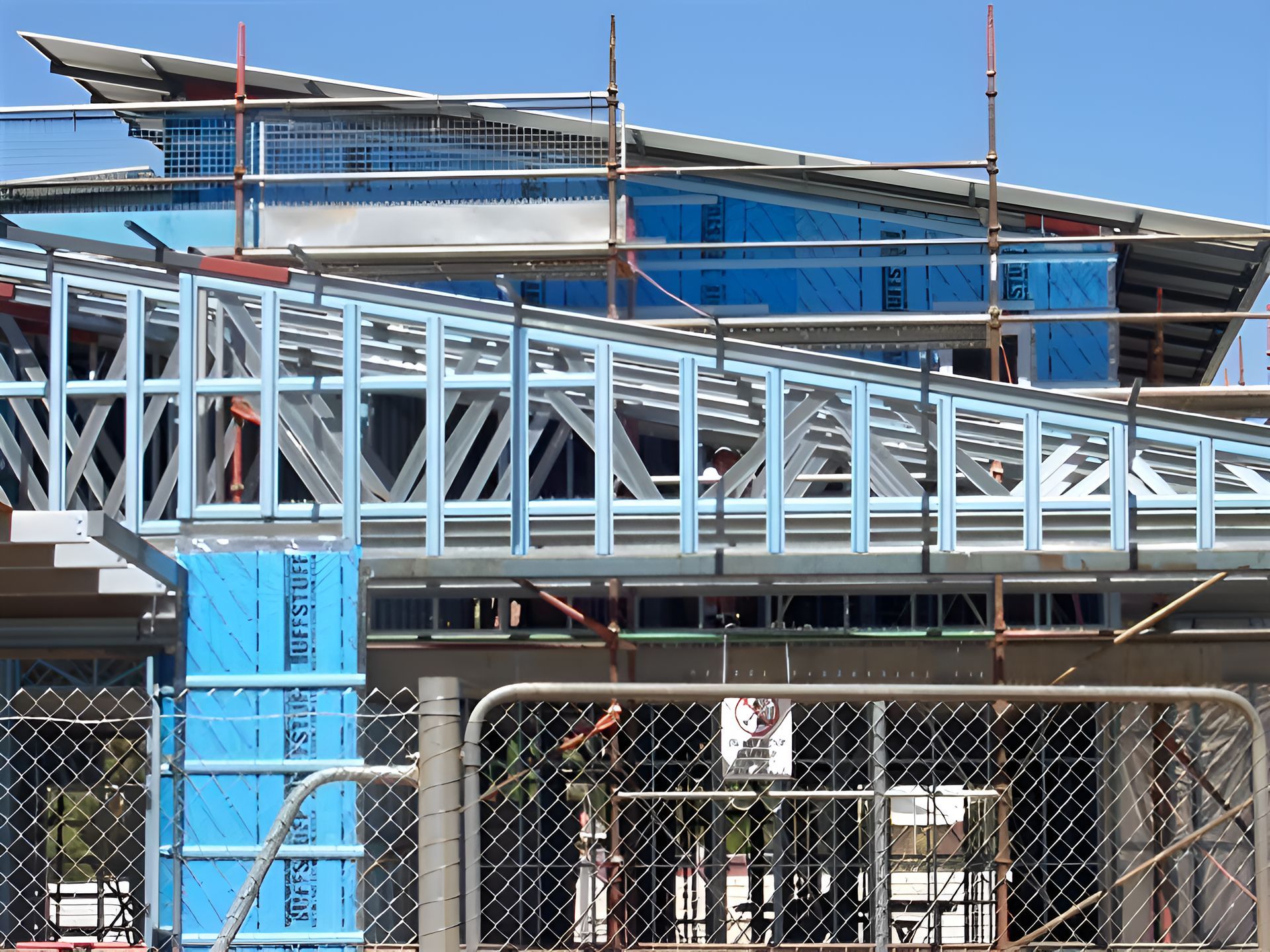 A Fence Surrounds A Building That Is Under Construction — Sno's Welding In Ciccone, NT