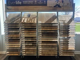 Display of stacked Everlife flooring samples on a store rack