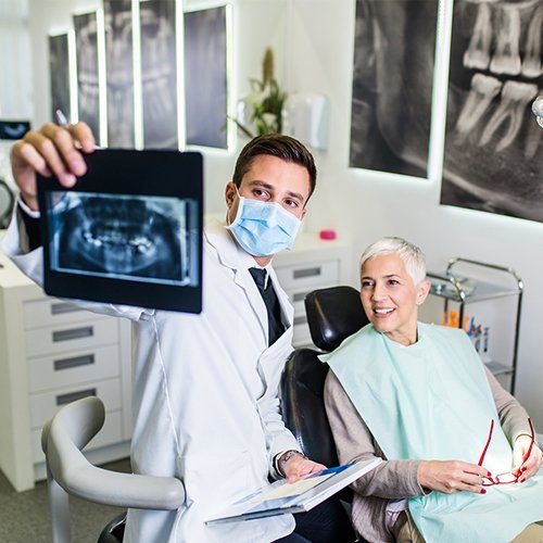 Male Dentist Checking Dental X-Ray Image of Senior Woman — Sylacauga, AL — O'Brien Family Dentistry