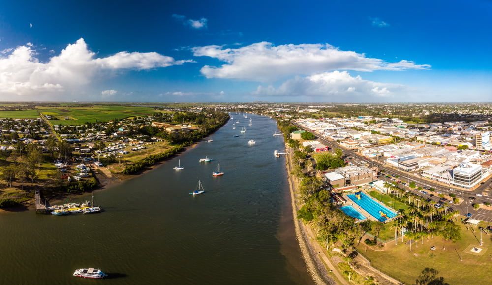 An Aerial View Of A River With Boats In It And A City In The Background — South Burnett Truck Rental In Bundaberg, QLD