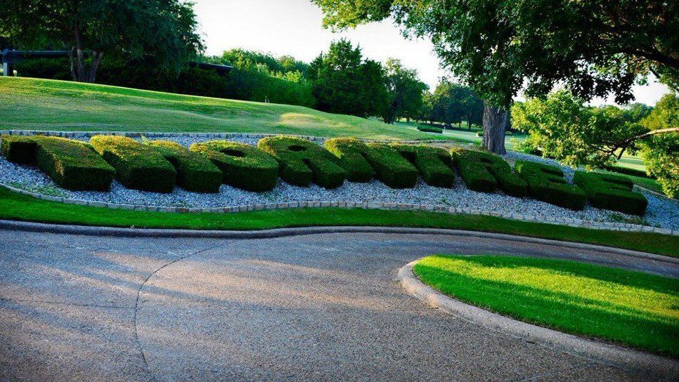 Aerial view of golf course with lake and fairways