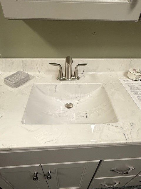 A bathroom sink with a soap bar on the counter