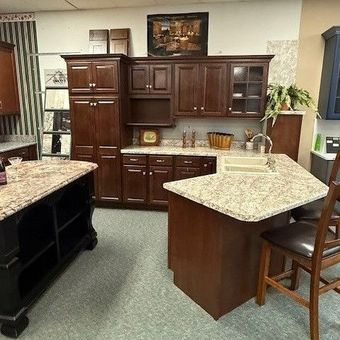 A kitchen with wooden cabinets and granite counter tops A kitchen with wooden cabinets and granite counter tops