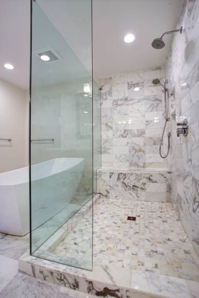 A bathroom with a walk in shower and a bathtub.