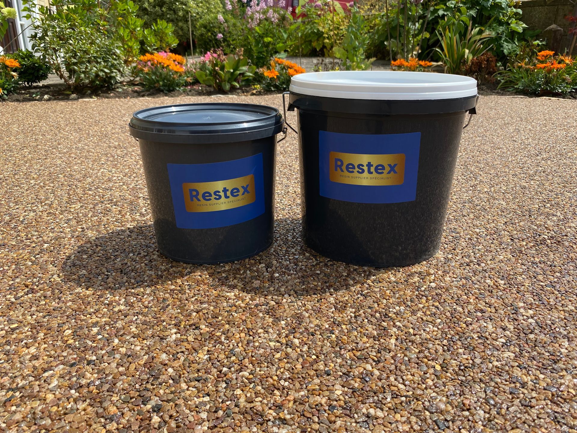 Image of Restex resin bound surface with 2 buckets on resin driveway dubai, UAE