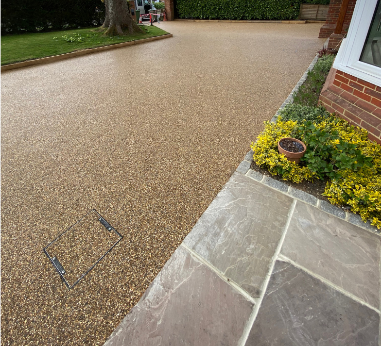 A driveway with a brick building in the background