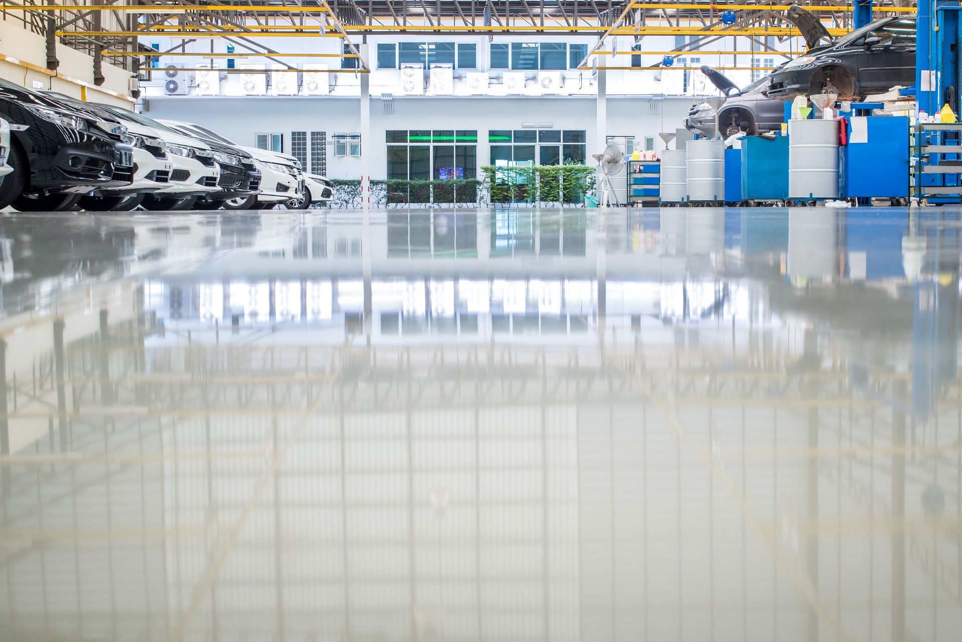 A large warehouse with a shiny floor and a lot of windows.