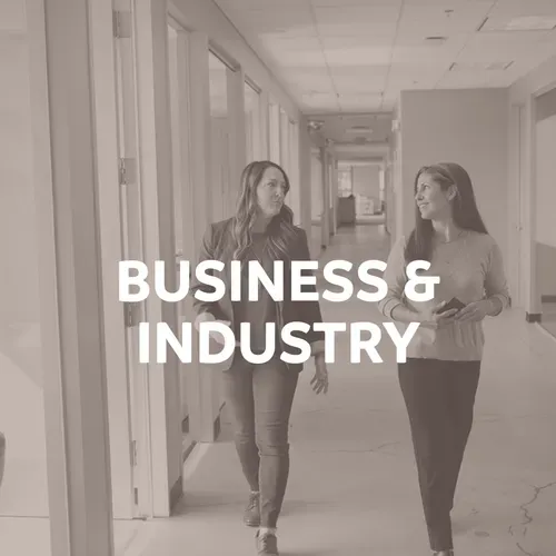 Two women walking in an office hallway; text reads 