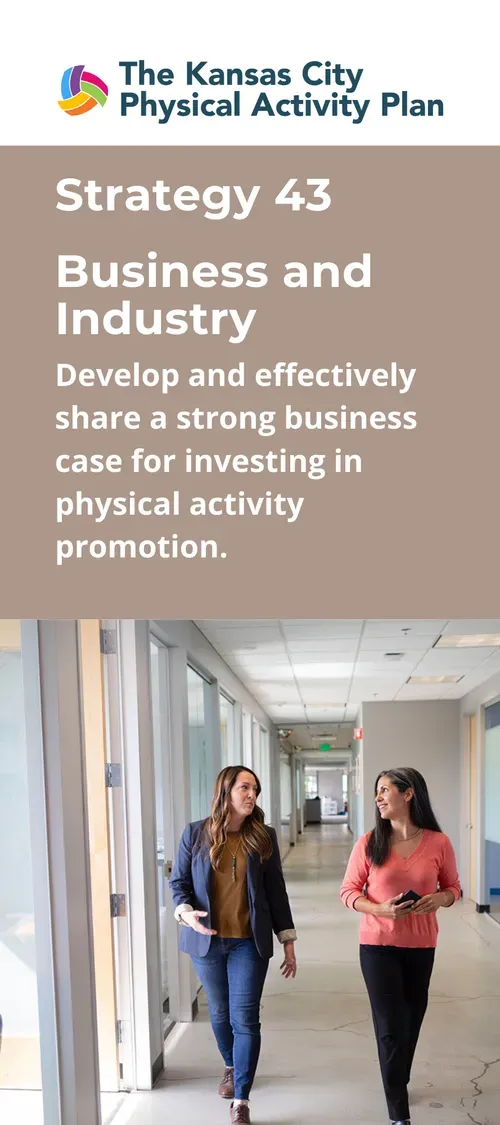 Two women walking in an office hallway; strategy for physical activity promotion.