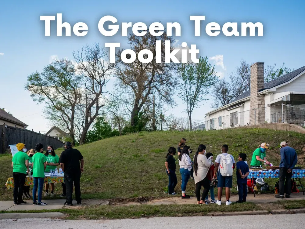 People at a table under a sign that reads 