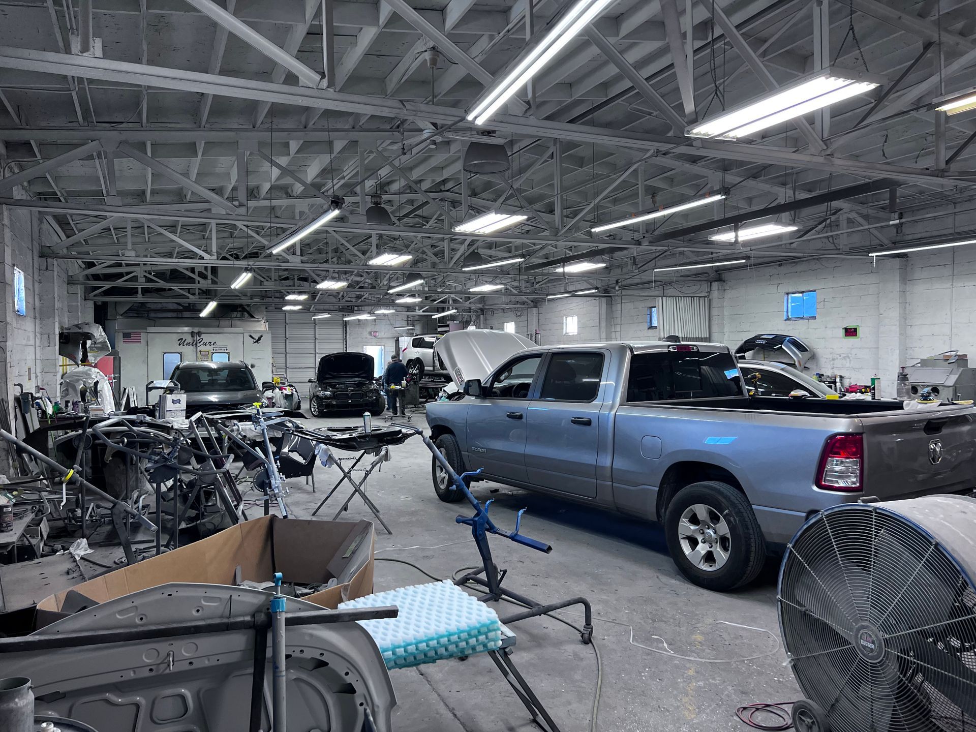 A blue truck is parked in a garage.