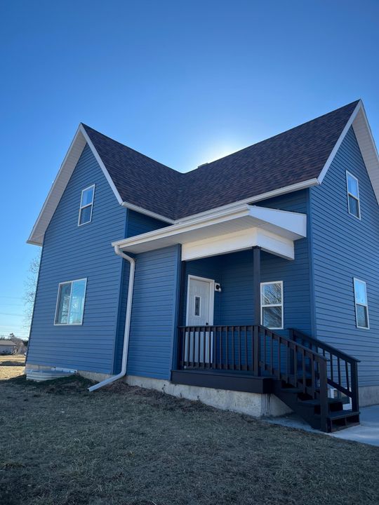 A ladder is sitting in front of a house under construction.