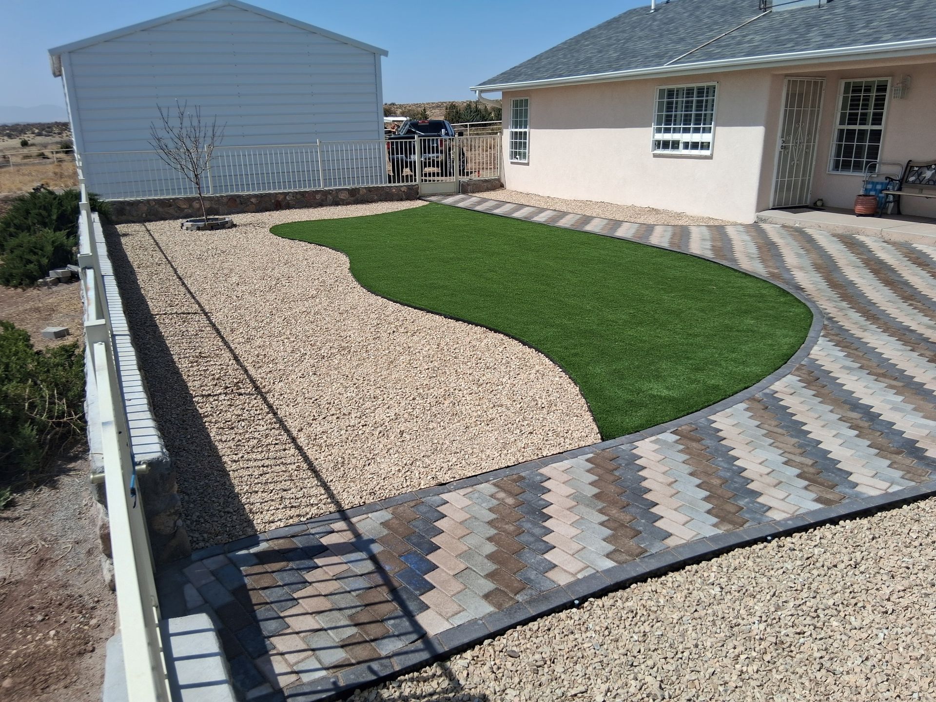 A house with a lawn and a walkway in front of it