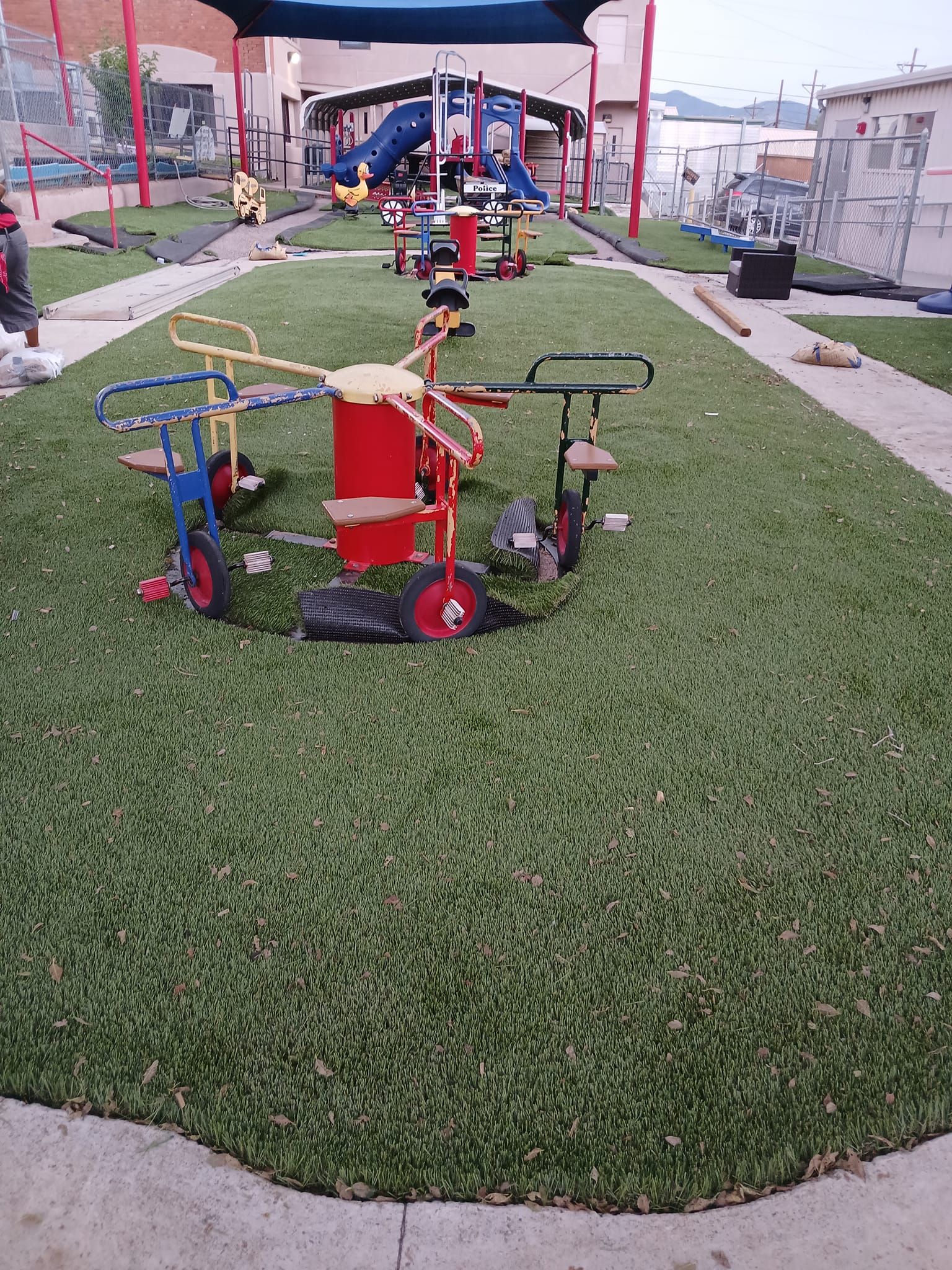A playground with a lot of toys on the grass.