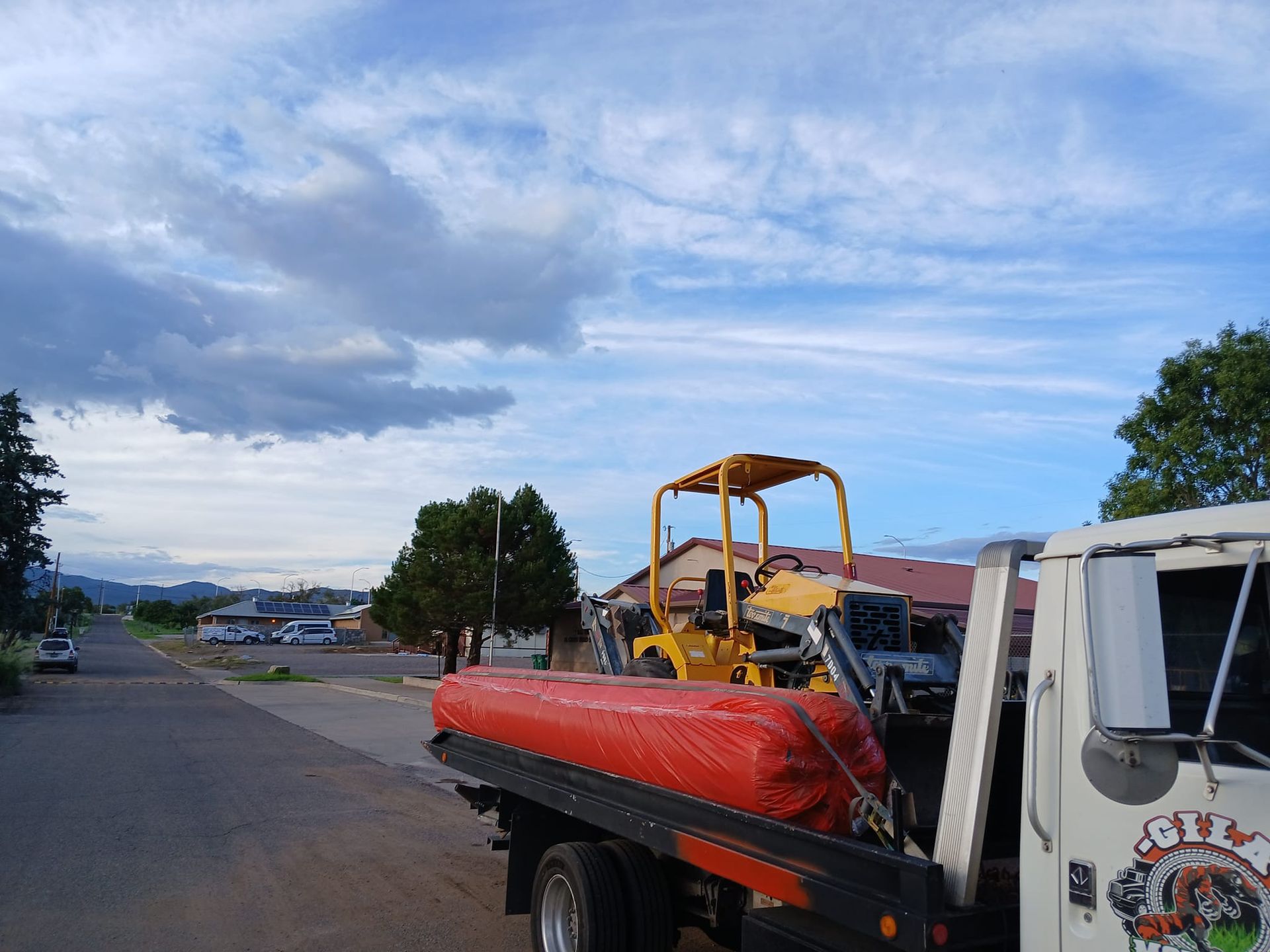 A tow truck with a red bag on the back of it