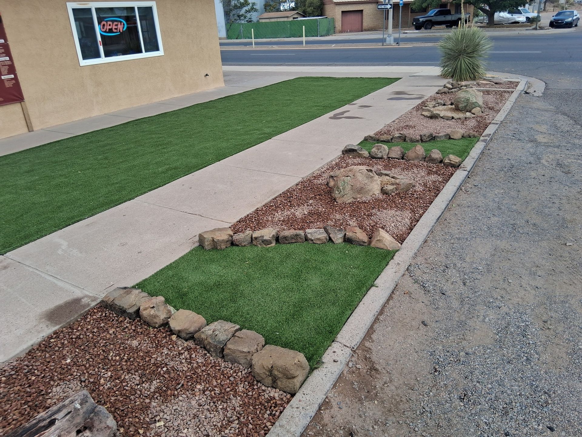 A sidewalk with a sign that says open on it