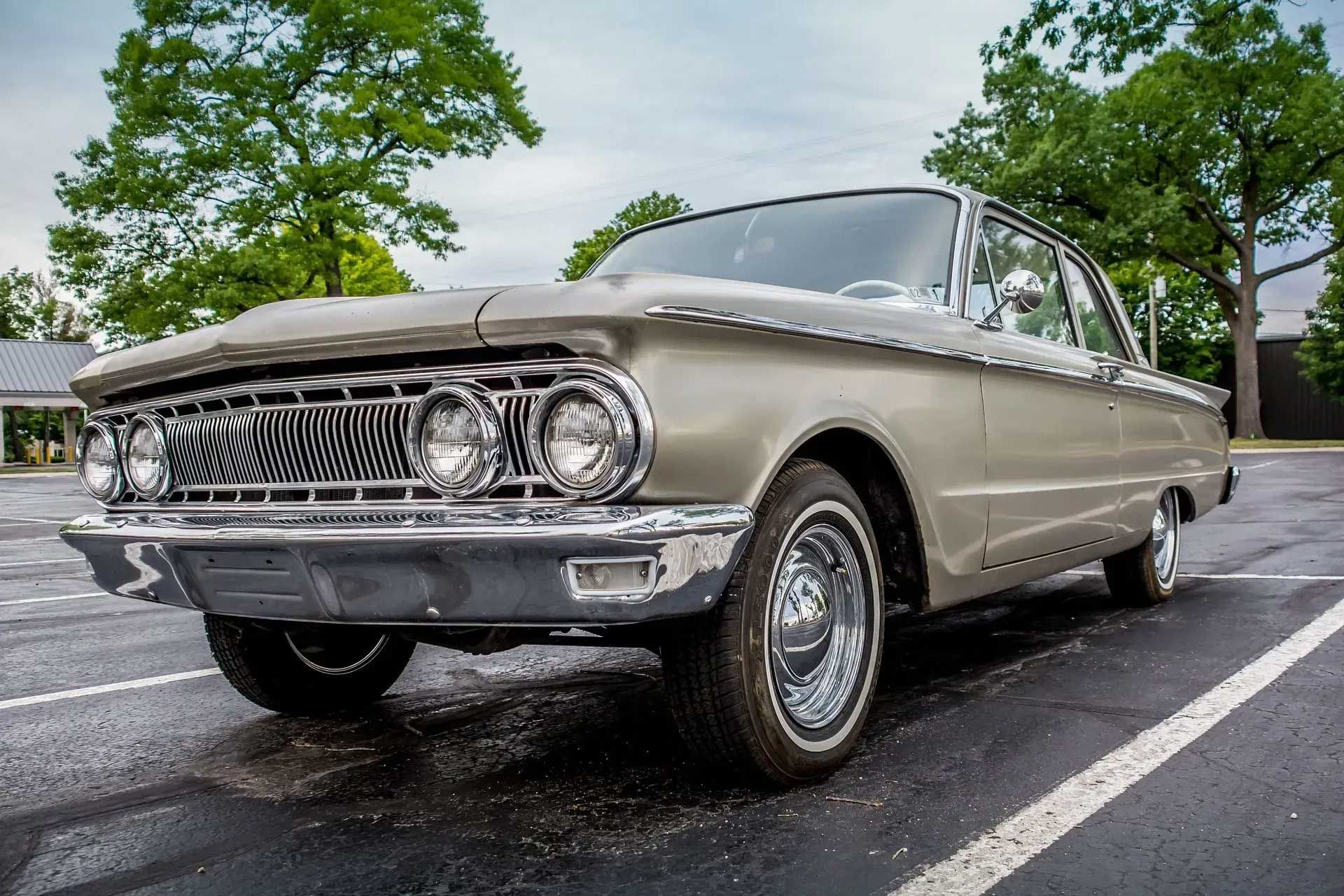 Gray vintage Mercury Comet car parked in a parking lot.