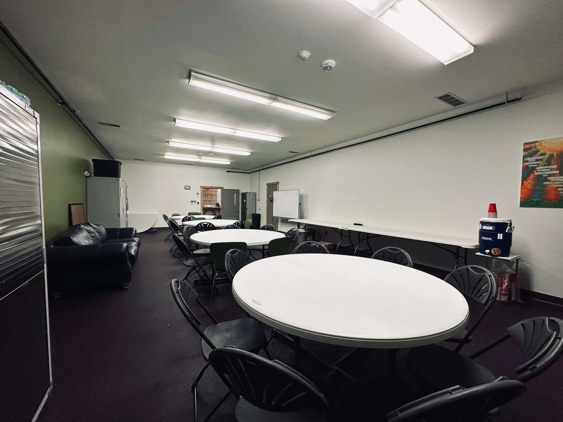 A large room with tables and chairs in it