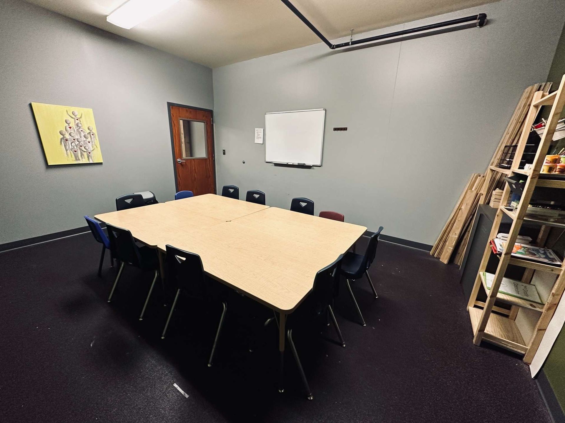 A conference room with a long table and chairs.