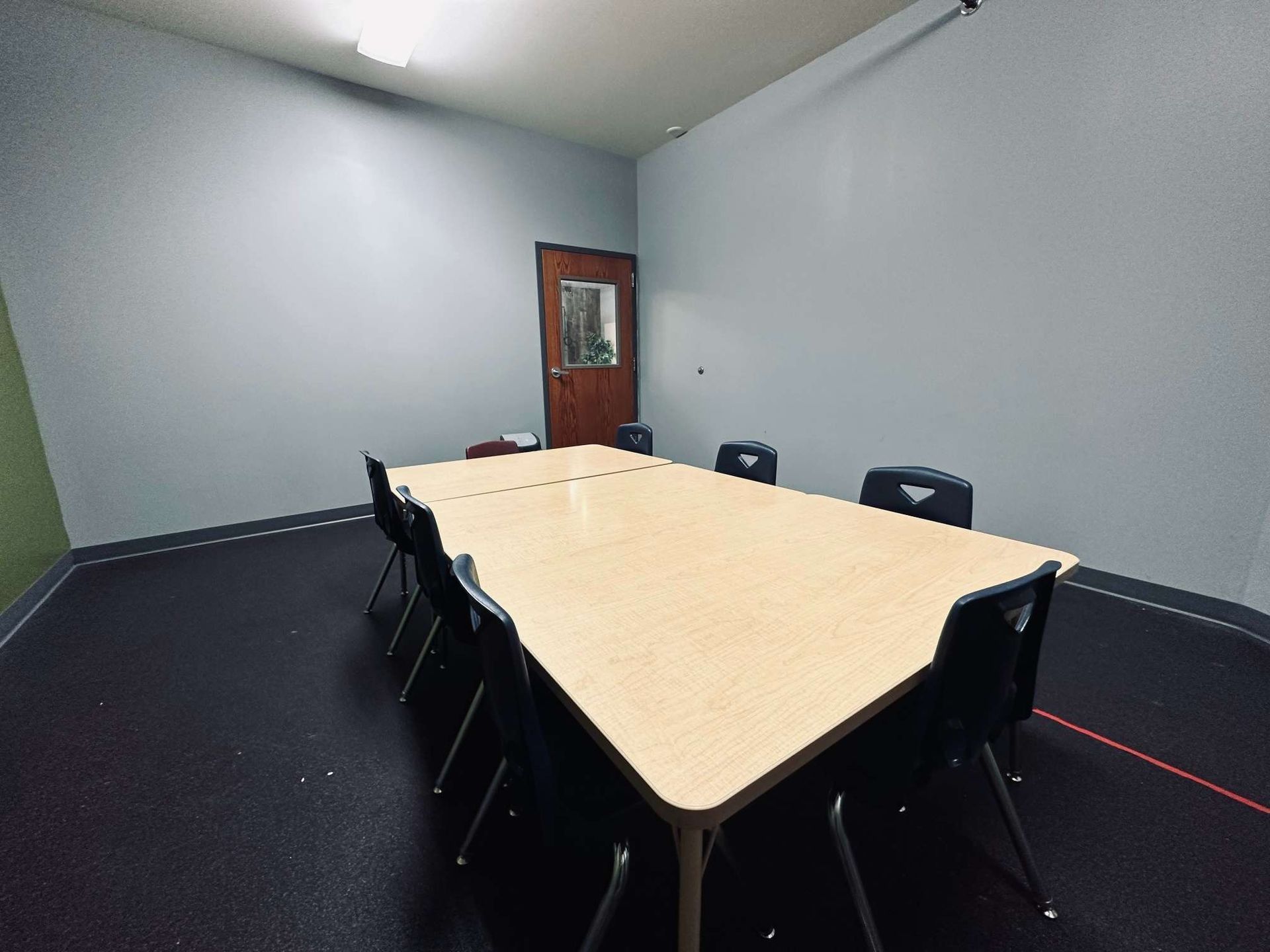 A conference room with a long table and chairs