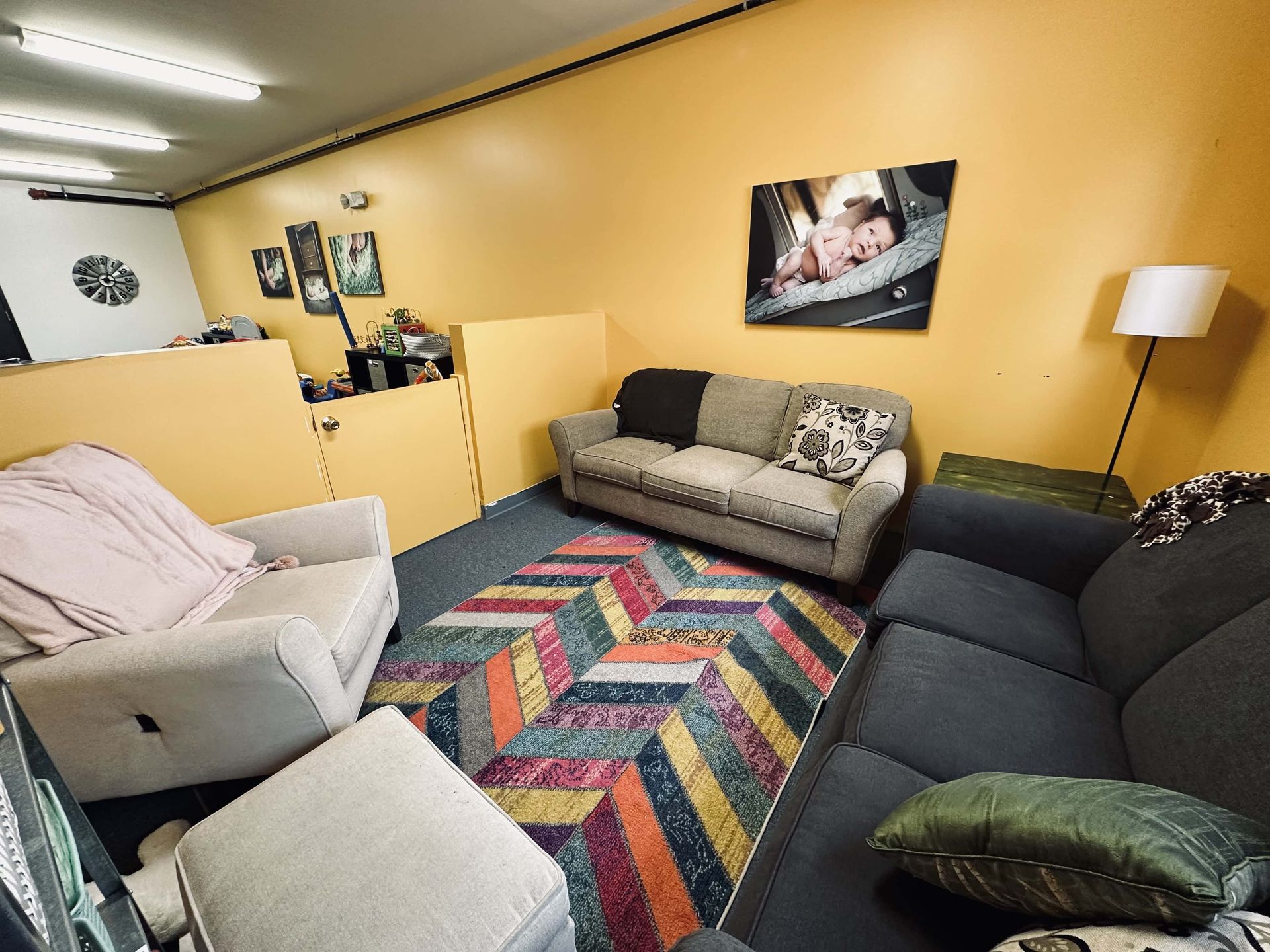 A living room with a couch , chair , and rug.