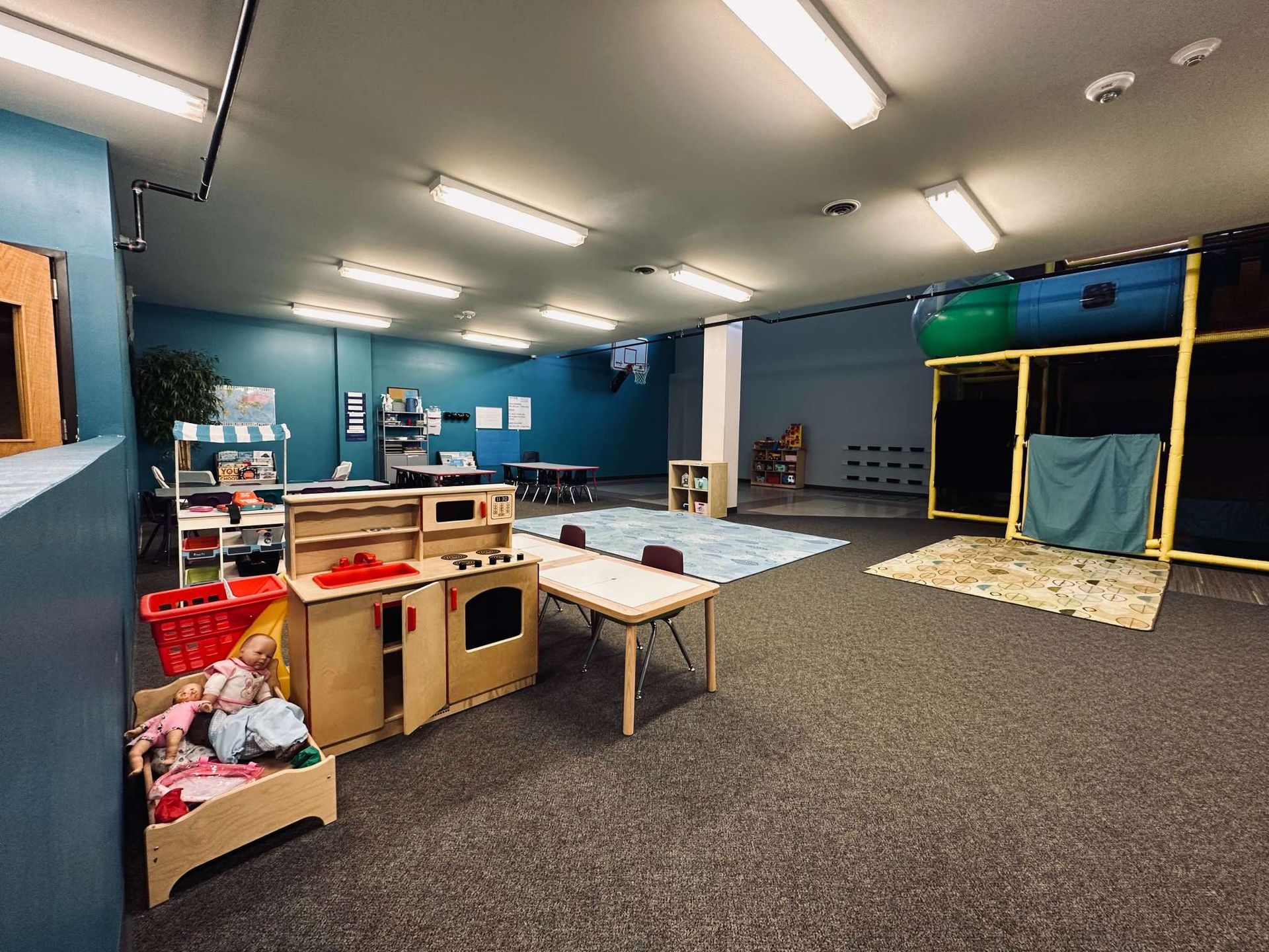 A large room with a lot of furniture and toys in it.