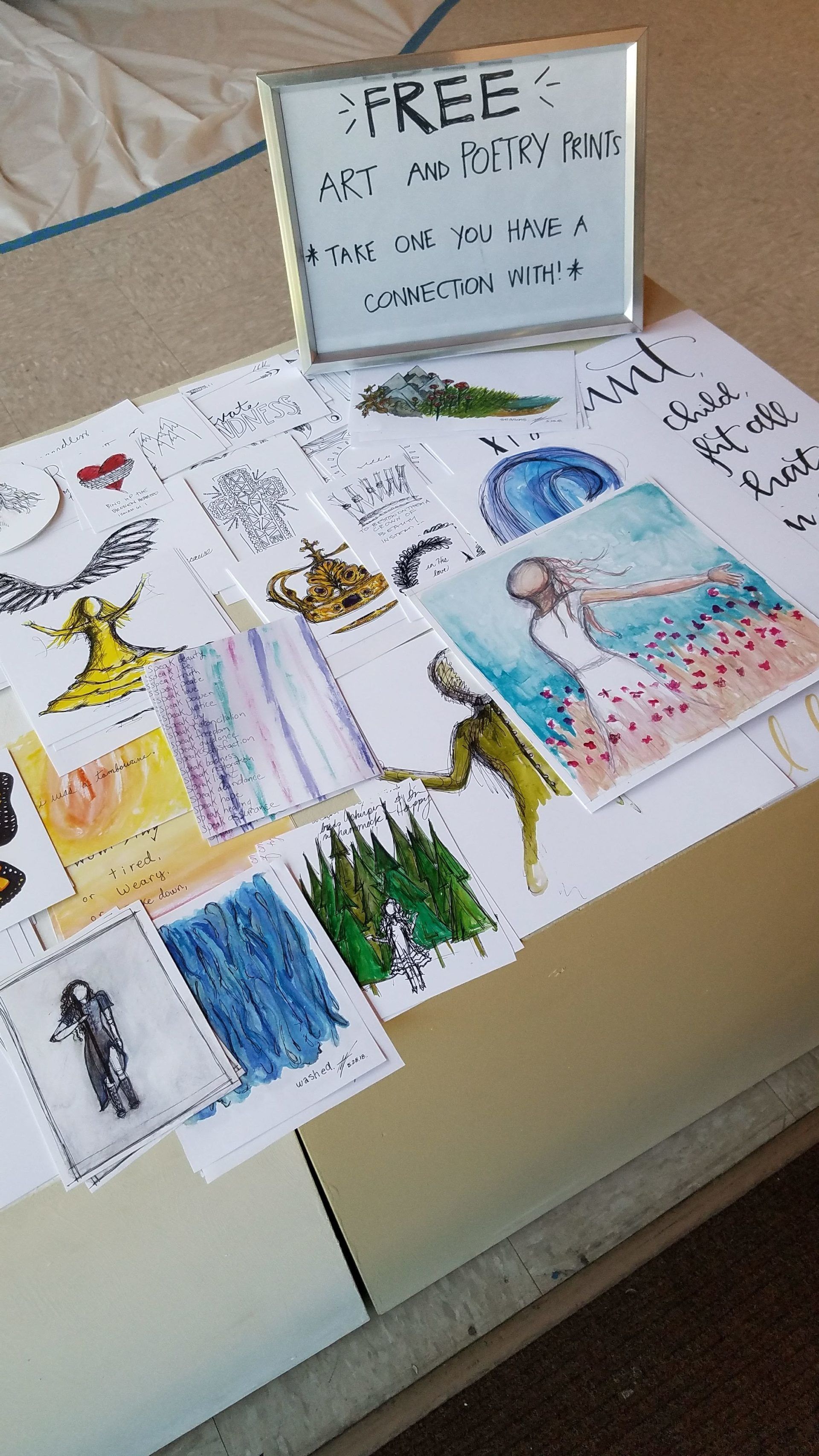 A table with a sign that says free art on it