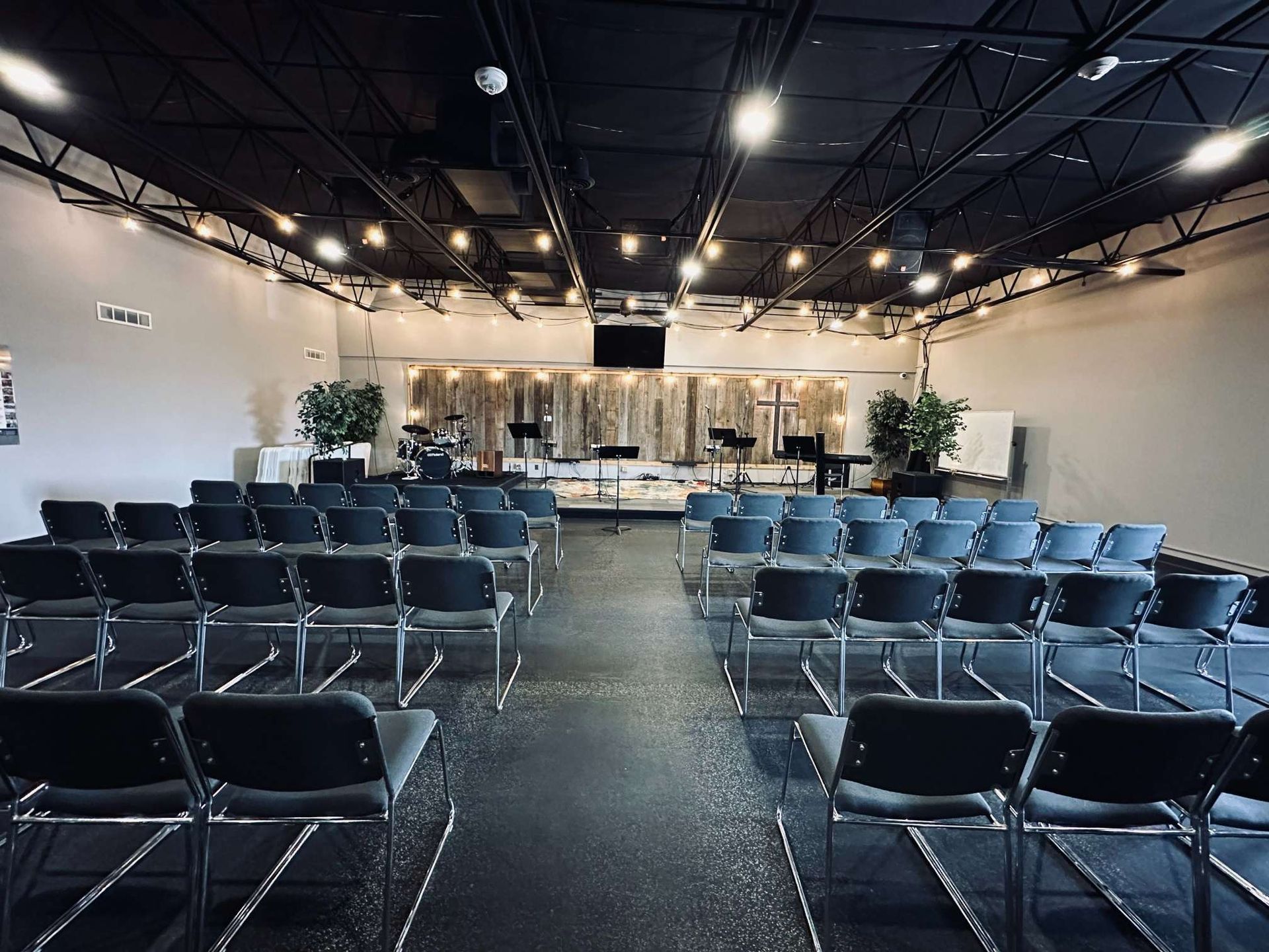 A large room with rows of chairs and a stage in the middle.