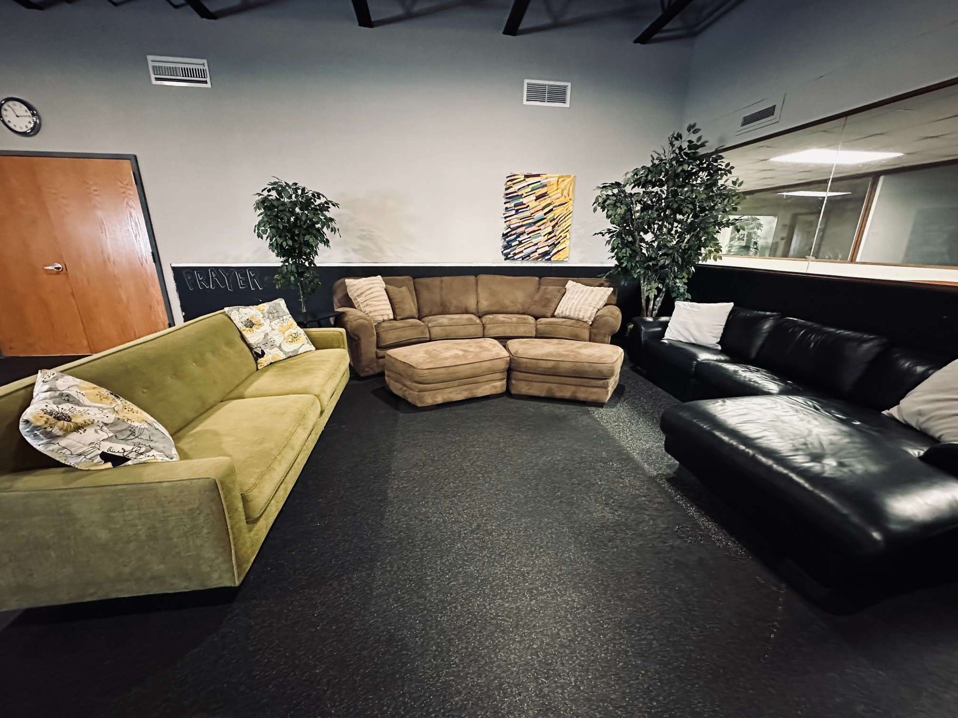 A living room with a lot of couches and ottomans